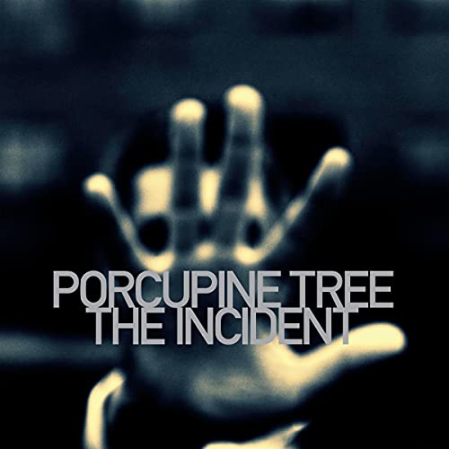 A blurry hand reaches forward against a dark background with white text overlaid.