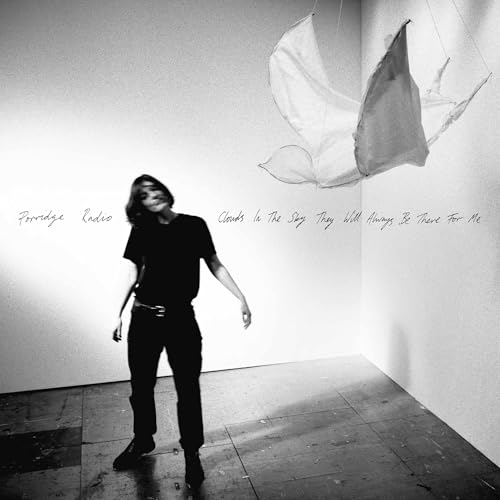 Black and white album cover with a person and hanging fabric shapes.