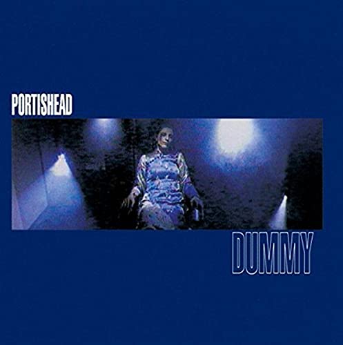 Blue album cover featuring a woman in a dress under spotlights.