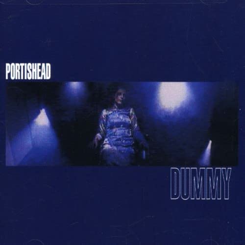 Portishead Dummy album cover featuring a grainy, dark blue image of a woman.