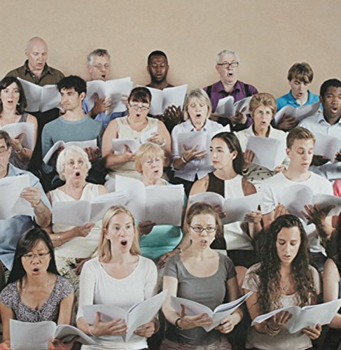 Choir singing with sheet music, diverse group of people performing.