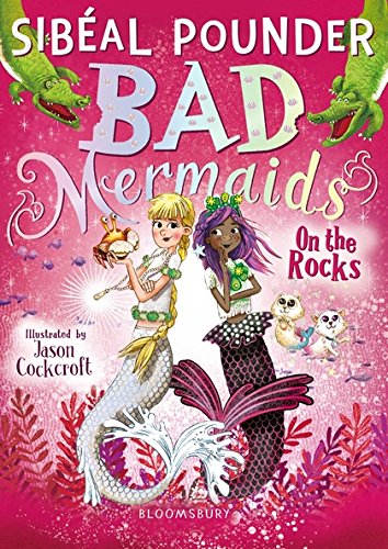 Book cover featuring two mermaids, crocodiles, and small sea creatures on a pink background.