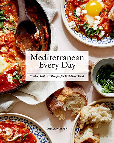 Cookbook cover featuring eggs in tomato sauce with bread and herbs.