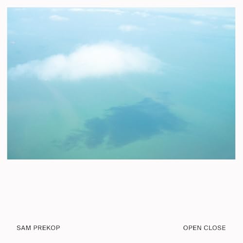 Album cover: aerial view of land and clouds in blue tones.