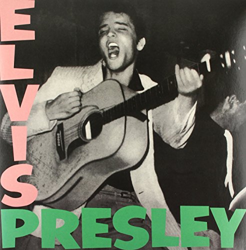 Black and white photo of Elvis Presley playing an acoustic guitar.