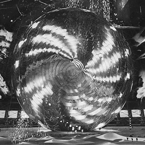 Black and white album cover featuring a large, reflective sphere.