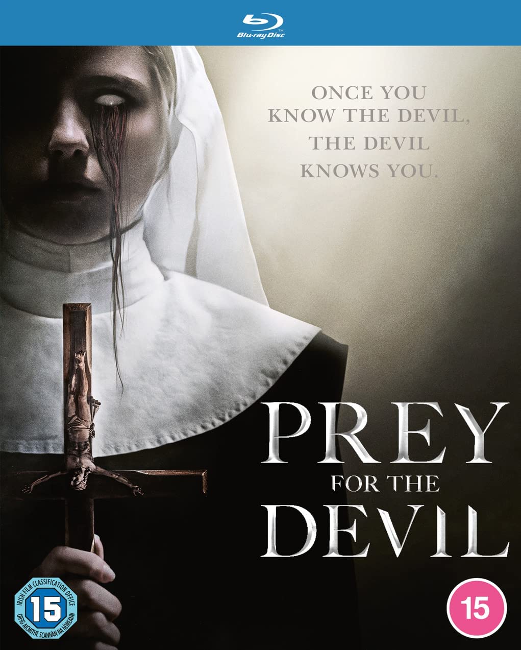 "Nun with blood-stained face holding a crucifix on a Blu-ray cover."