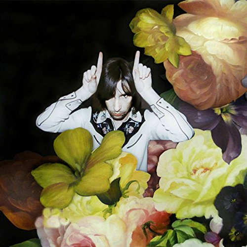 The image depicts a man surrounded by flowers, with his middle fingers raised.
