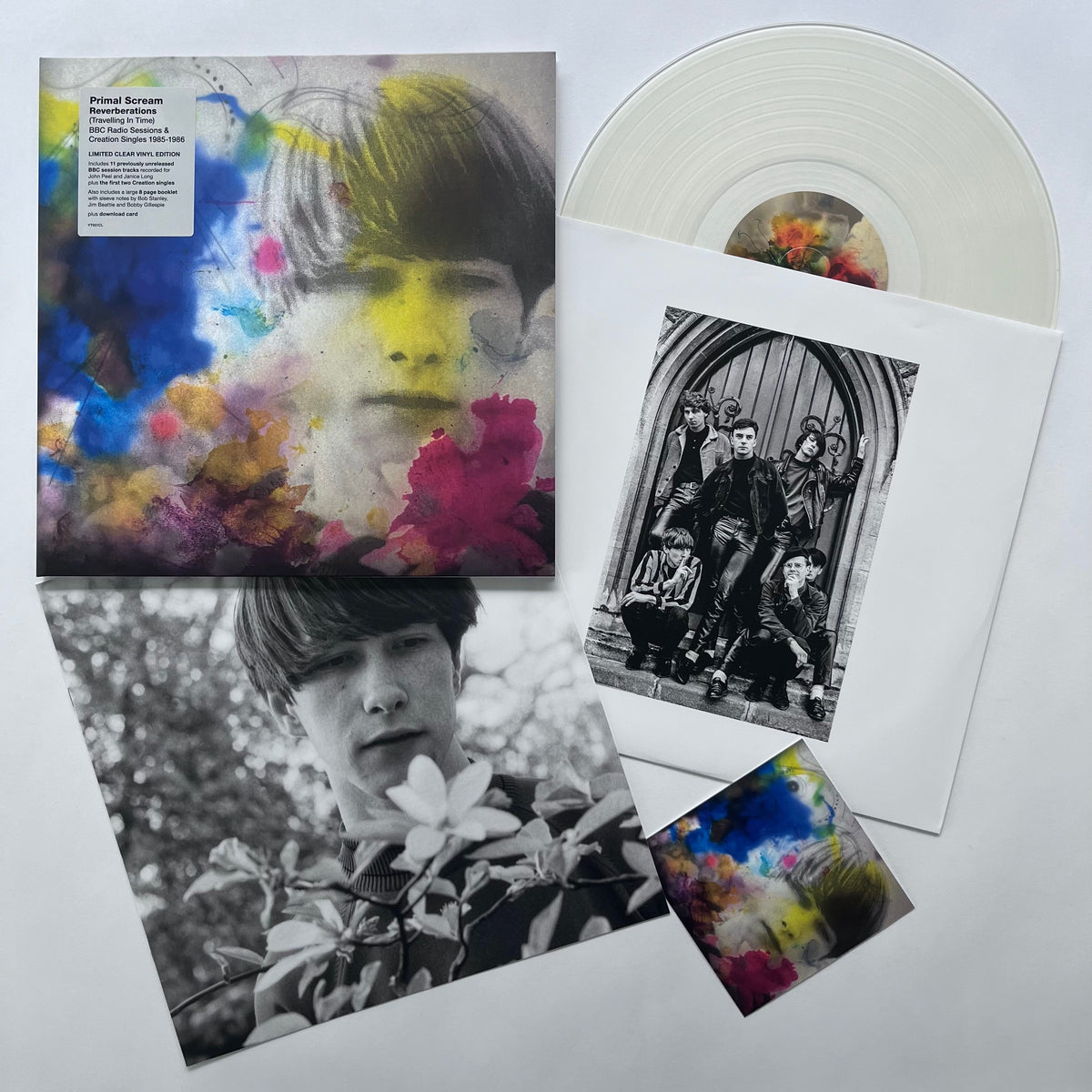 "Clear vinyl record with album cover and booklet featuring black and white and colorful images."