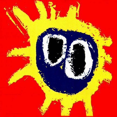 Red album cover with a yellow sunburst and dark blue central eye shape.