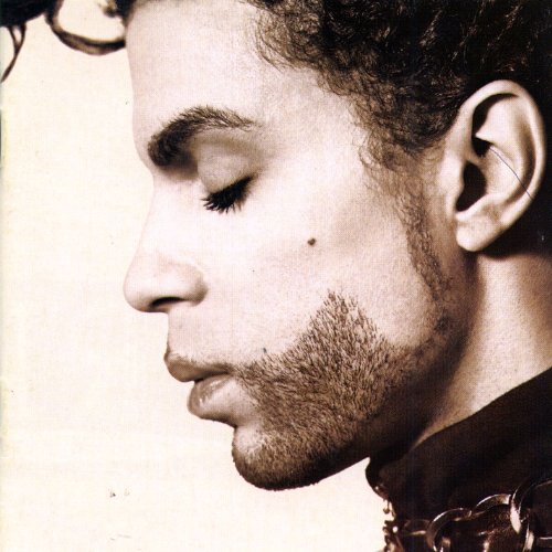 Close-up profile of Prince with eyes closed and a groomed beard.