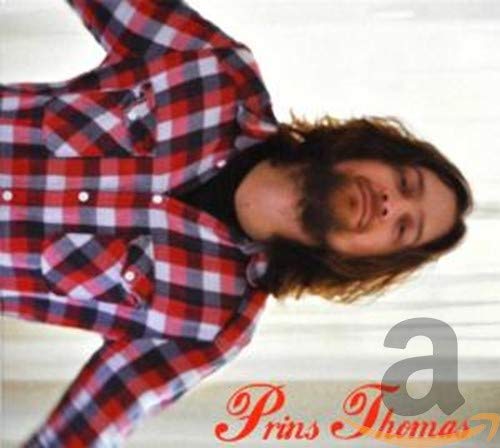 Man with long hair and beard wearing a red plaid shirt.