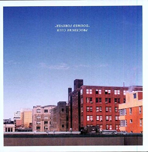 Vinyl record cover with a blue sky and brick buildings.