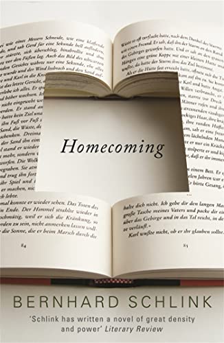 Open book displaying the title "Homecoming" and author Bernhard Schlink.