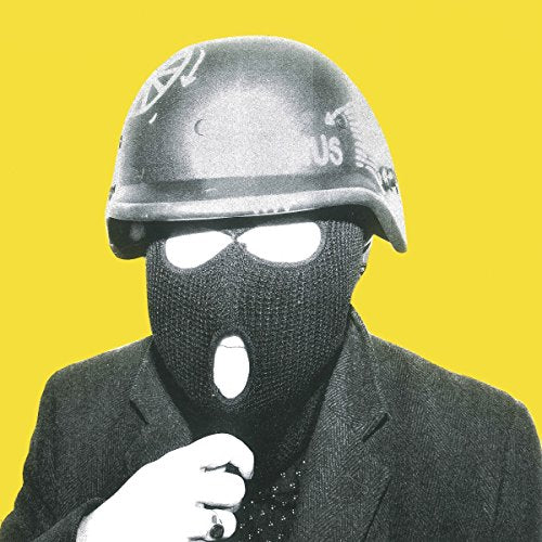 "Man wearing a black ski mask and US military helmet against a yellow background."