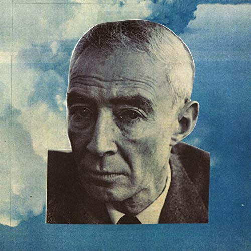 Close-up portrait of an older man against a textured blue and white background.