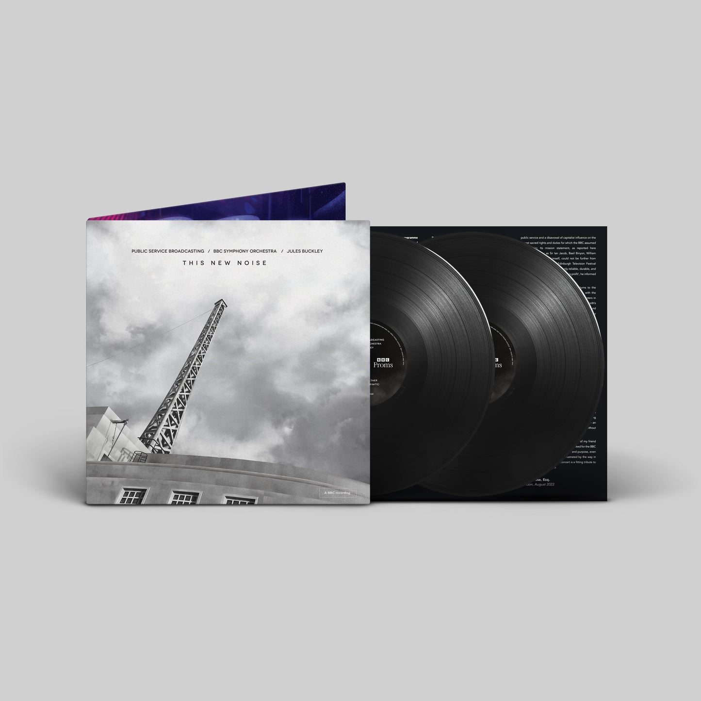 Vinyl record album cover with black and white image and two vinyl records inside.