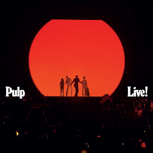Silhouetted band Pulp performing on stage before a large red circle.