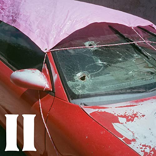 Red car with cracked windshield and pink tarp, album art.