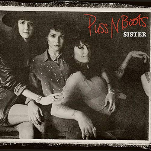 "Puss N Boots album cover featuring a black-and-white photo of three band members."