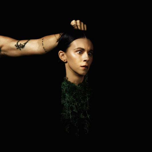 PVRIS album cover: woman with moss around neck, arm obscuring head.