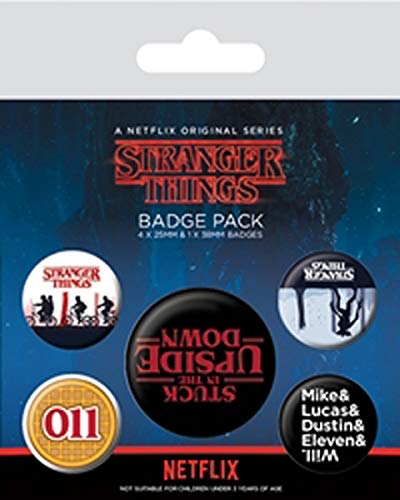 Stranger Things badge pack with four round pins on a cardboard backing.