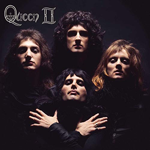 Queen II album cover featuring four band members in dark clothing.
