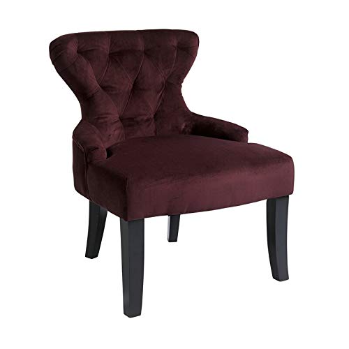 Dark purple velvet armchair with tufted back and dark wood legs.