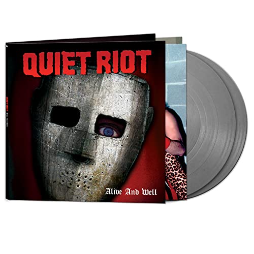 Vinyl record and cover featuring a weathered mask and the text Quiet Riot.