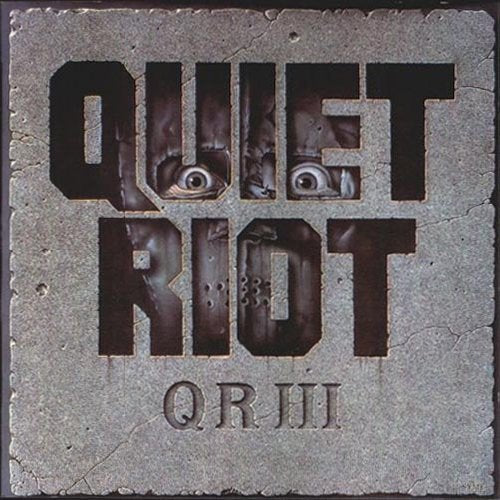 CD case with Quiet Riot logo and musical artwork, likely featuring a black background.