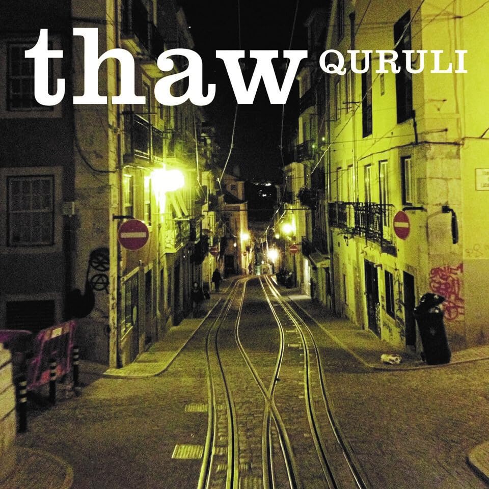 Album cover for Quruli’s “Thaw” showing a narrow, nighttime city street.