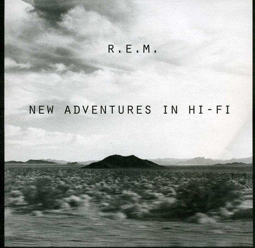 R.E.M. album cover: desert landscape under cloudy sky, text reads "New Adventures In Hi-Fi".
