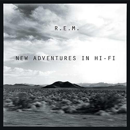 R.E.M. album cover: desert landscape under cloudy sky, text "New Adventures In Hi-Fi".