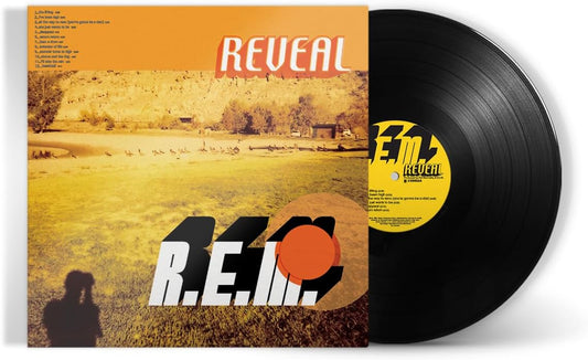 "Vinyl record with 'Reveal' album cover featuring a landscape and R.E.M. logo."
