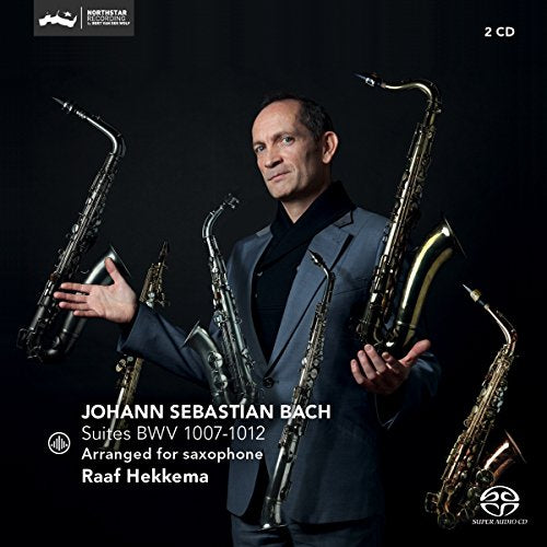 Raaf Hekkema in a suit surrounded by several saxophones on a black background.