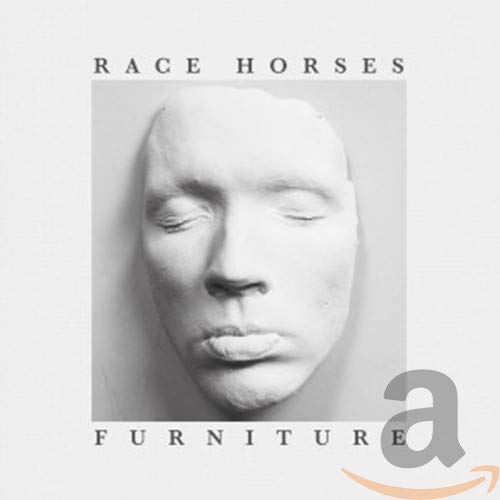 CD cover: grayscale image of a human face with the word "furniture".