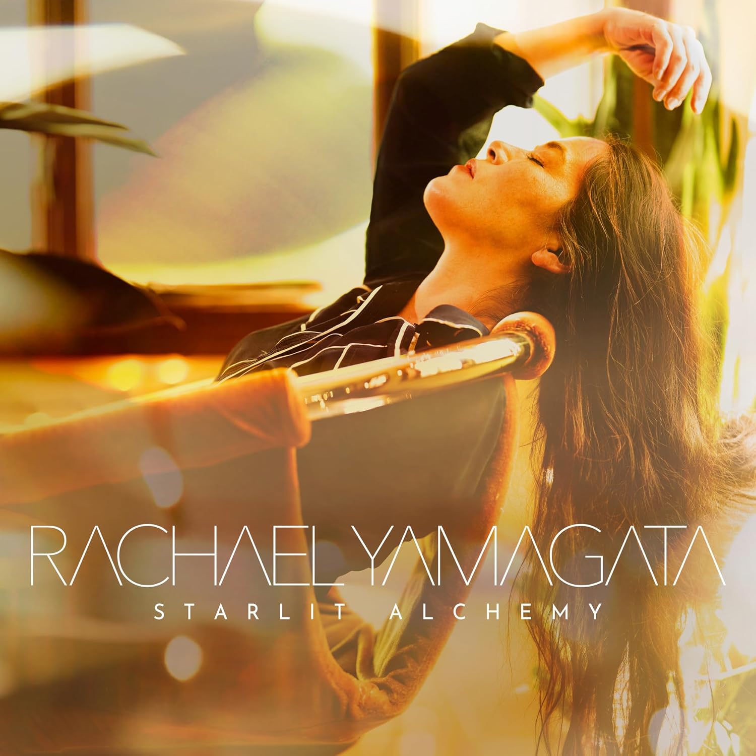 Album cover for Rachael Yamagata’s “Starlit Alchemy” featuring a woman with a harp.