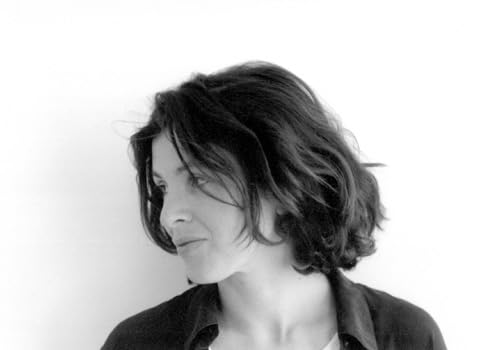 Black and white portrait of a woman with short, wavy hair.