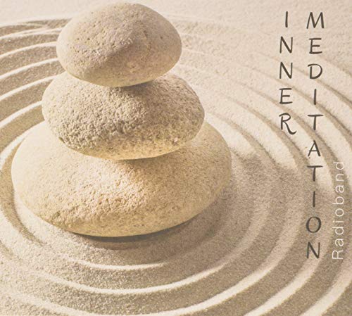 Stacked stones on sand with the word "Meditation" vertically displayed.
