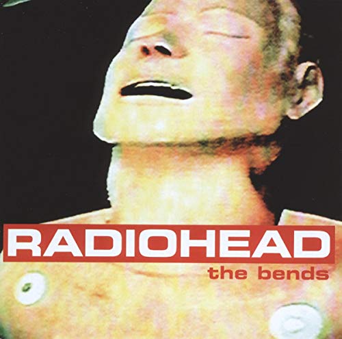 Album cover showing a pale, mannequin-like face against a black background with red text.