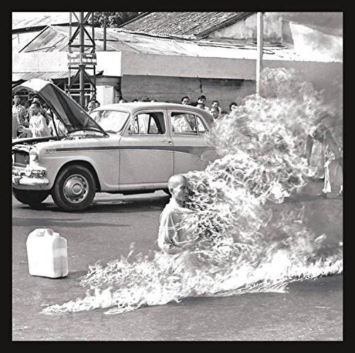 Black and white album cover depicting a protest with flames and a car.