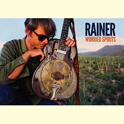 Man with resonator guitar outdoors, album cover for Rainer Ptacek’s “Worried Spirits.”