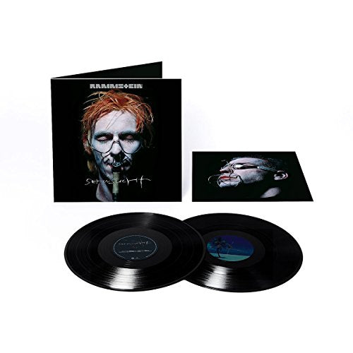 "Album cover featuring a man's face with a wired mouth on black background."