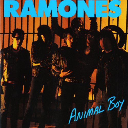 The Ramones band members in leather jackets, standing before metal bars.