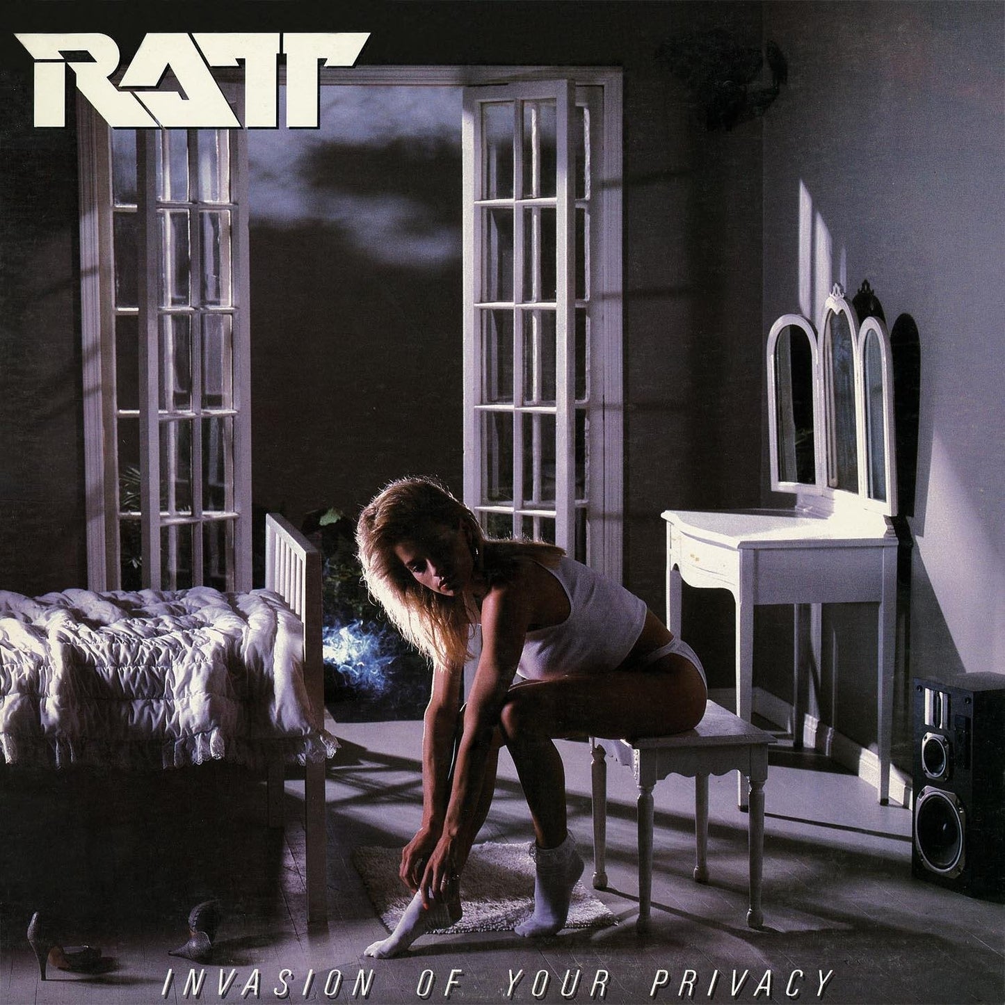 Ratt album cover: woman in a dimly lit, ornate room.