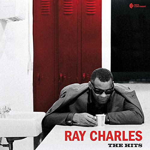 Ray Charles wearing sunglasses, leaning on a table with a cup, red lockers behind.