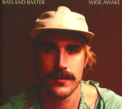 Rayland Baxter album cover, close-up portrait of a man in a hat.