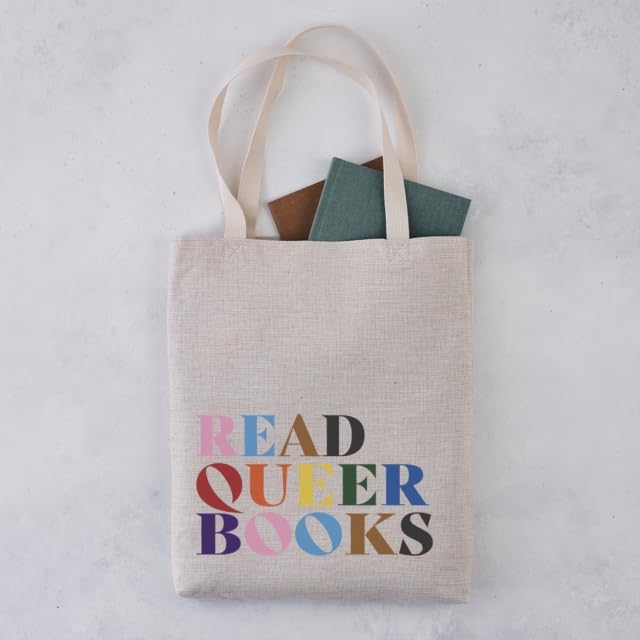 Beige tote bag with rainbow text “Read Queer Books” and books inside.