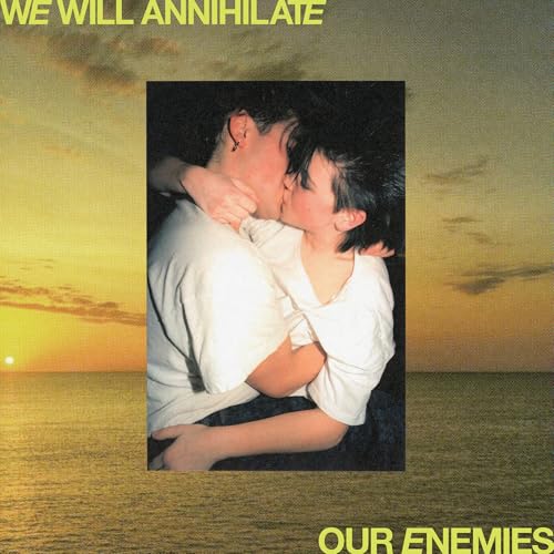 Two people in white shirts embrace and kiss against a sunset ocean background.