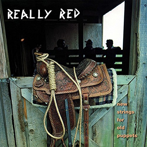 Record cover: Western saddle on weathered wood, figures in background.